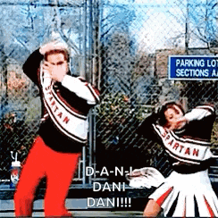 two spartan cheerleaders are dancing in front of a fence