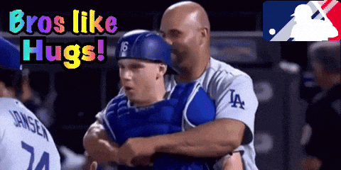a man in a la jersey hugs another man
