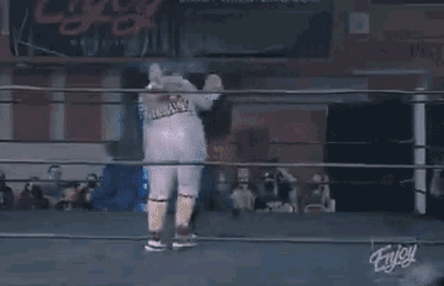 a man in a wrestling ring is wearing a shirt that says ' slayer ' on it