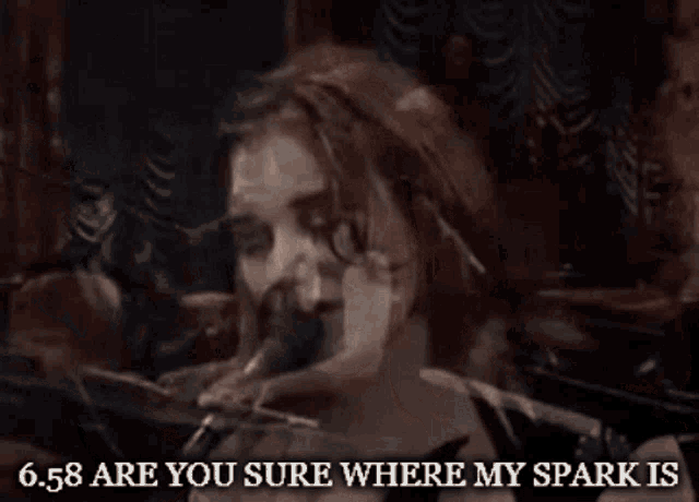 a woman singing into a microphone with the words 6.58 are you sure where my spark is written below her