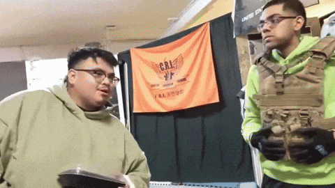 two men are standing in front of a banner that says cal