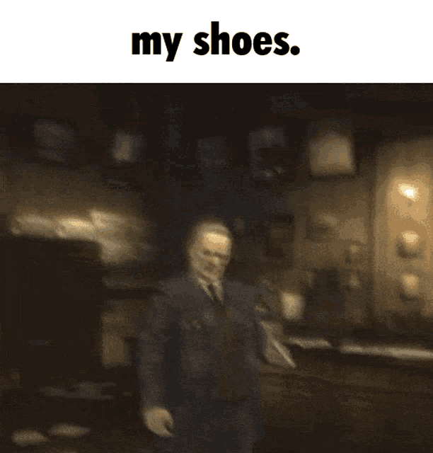 a blurred image of a man in a suit and tie with the words my shoes below him