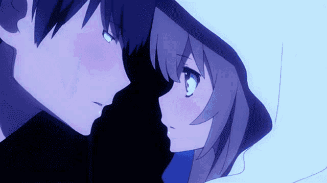 a boy and a girl are looking at each other in a dark room