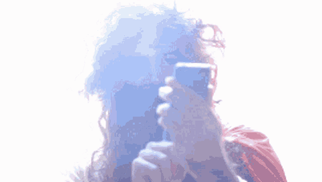a man with a beard is taking a picture with his phone