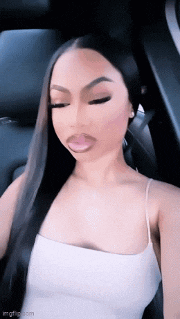 a woman with long hair is sitting in the back seat of a car .