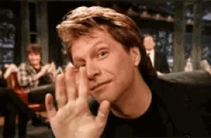 a close up of a man 's face with a waving hand