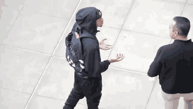 a man wearing a black hoodie with the word life on the back