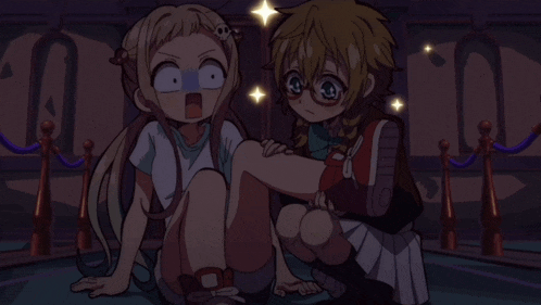 a girl with a skull on her head sits next to a girl with glasses