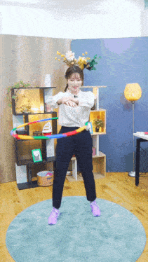 a woman playing with a hula hoop in a room