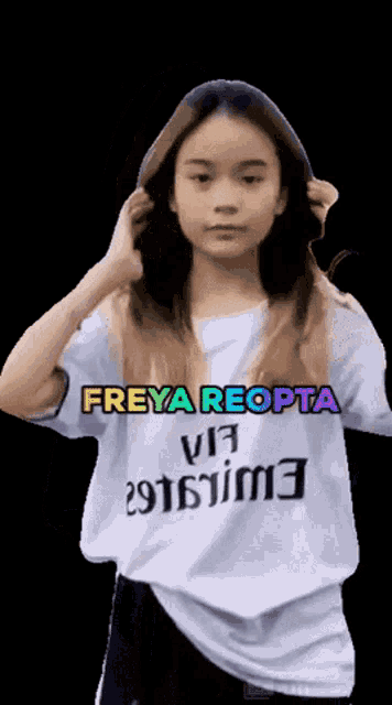 a girl wearing a white shirt with the name freya reopta on it