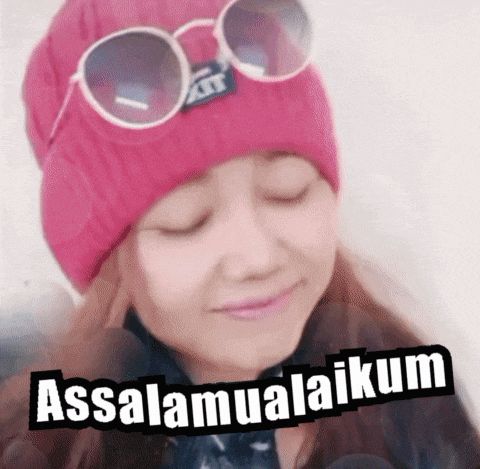 a woman wearing a pink beanie and sunglasses says " assalamualaikum "
