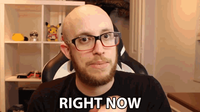 a bald man with glasses says right now