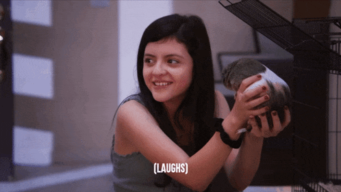 a girl holding a guinea pig with the word laughs above her