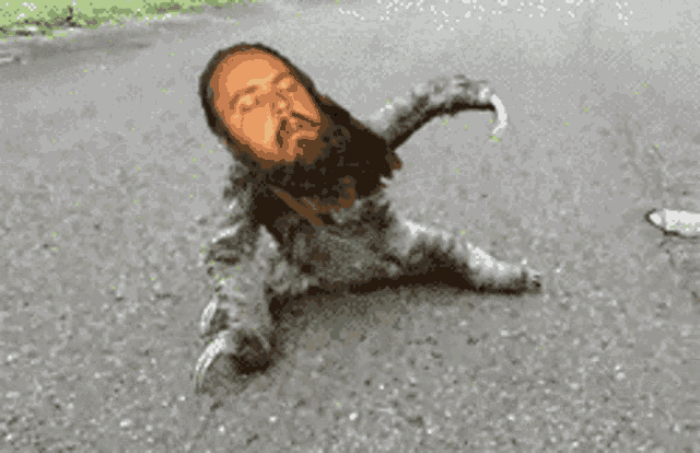 a man with a beard is laying on the ground with his head on the ground