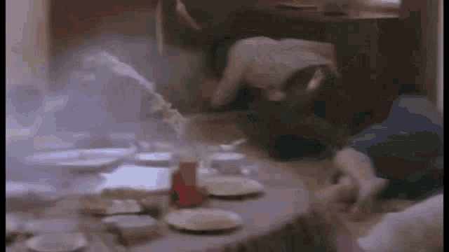 a blurred image of a table with plates and cups