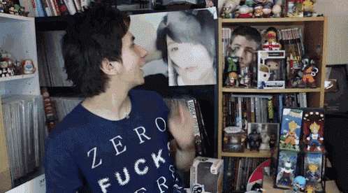 a man wearing a blue shirt that says zero fuck ers