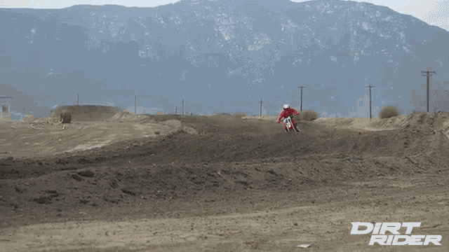 a dirt rider rides a dirt bike on a dirt track