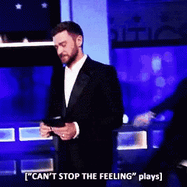a man in a tuxedo is holding a cell phone and saying " can 't stop the feeling plays " .