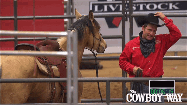 a man in a cowboy hat stands next to a horse in front of a sign that says " the cowboy way "