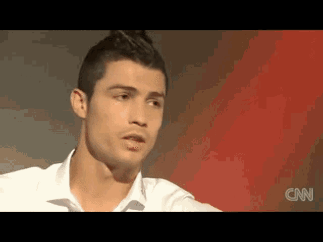 a close up of a man 's face in a white shirt .