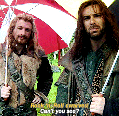 two men holding umbrellas with the words rock n roll dwarves can t you see on the bottom