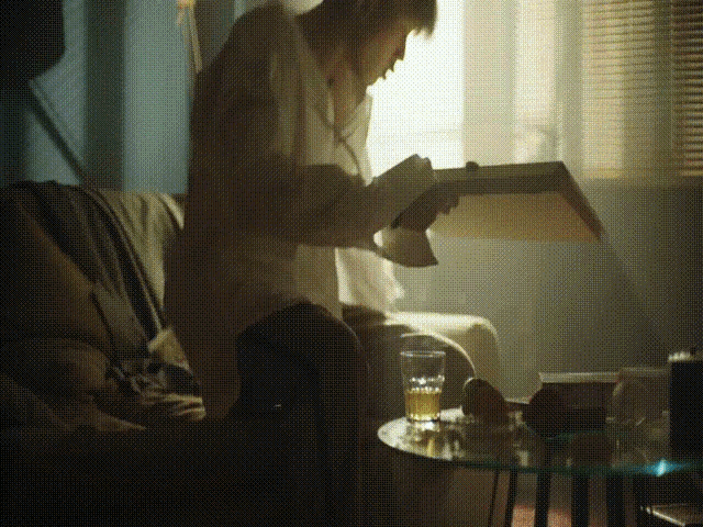 a person reading a book while sitting on a couch