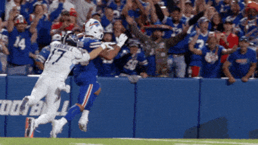 a buffalo bills player catches a pass from another player