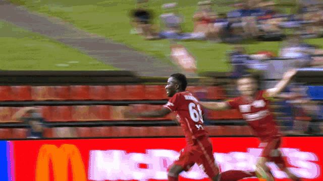 a soccer player wearing a red jersey with the number 6 on it