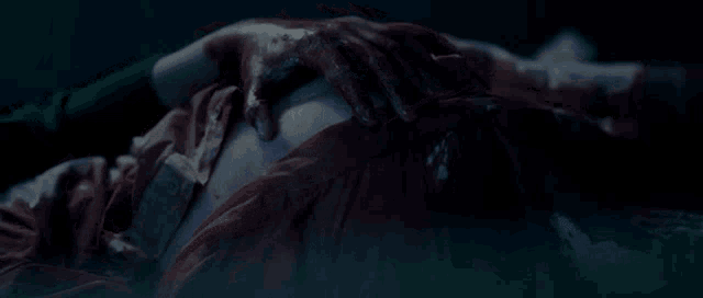 a person laying down with blood on their chest