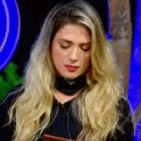 a woman with long blonde hair is wearing a black choker and a black jacket .