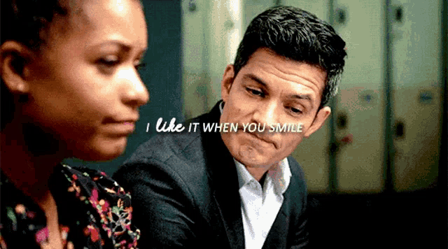 a man and a woman are sitting next to each other with the words " i like it when you smile " on the bottom