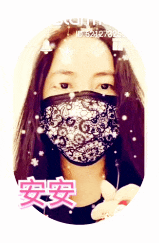 a woman wearing a black and white lace face mask with chinese characters around her face