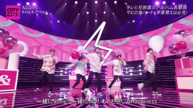 a group of people dancing on a stage with a sign that says cdtv on it