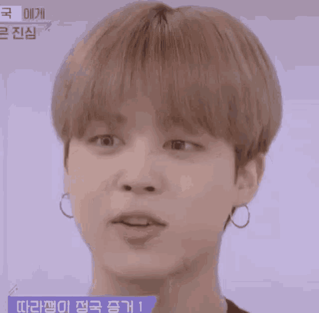 a close up of a person 's face with a very short haircut .