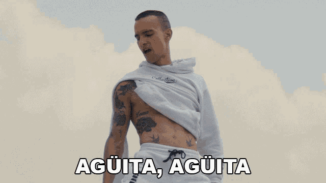 a man with a tattoo on his chest is standing in front of a cloudy sky with the words agüita agüita written below him