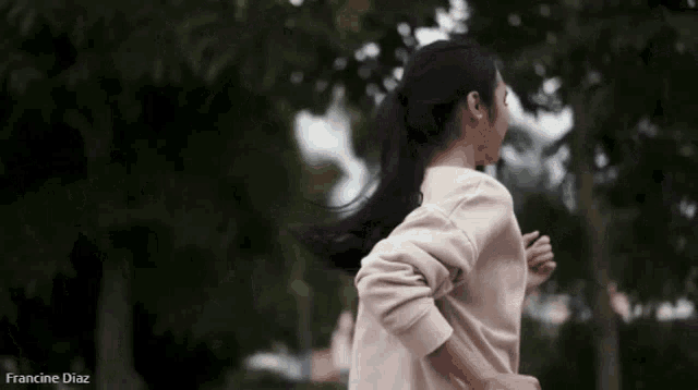 a woman is running in a park with the name francine diaz written below her