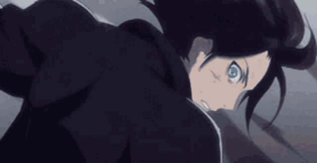 a man with blue eyes and black hair is laying on the ground .