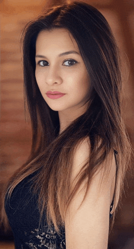 a woman with long dark hair is wearing a black top