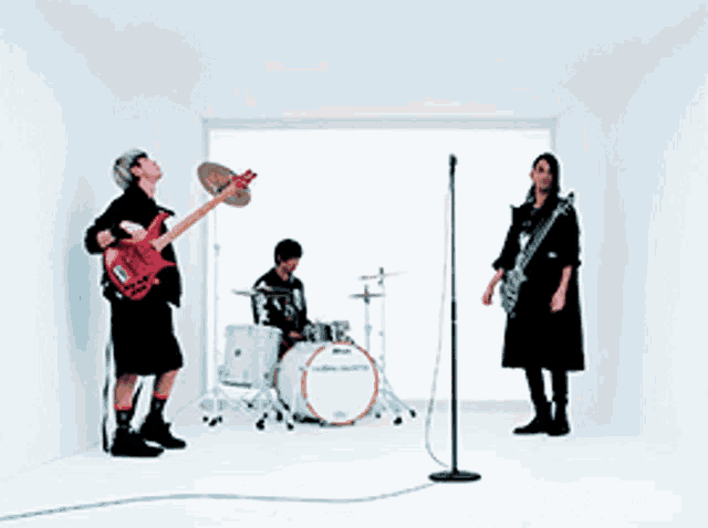 a group of people are playing instruments in a room