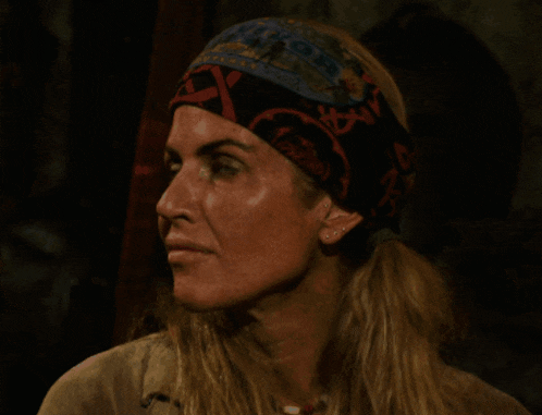 a woman wearing a scarf and a hat that says survivor on it