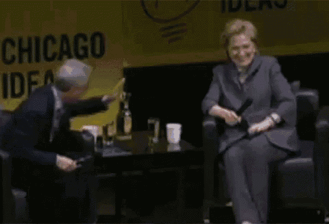 a man and woman are sitting in front of a sign that says " chicago ideas "