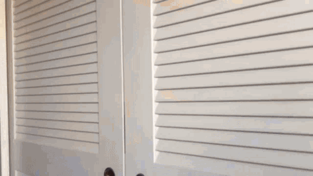 a person 's hand is reaching out to open a door