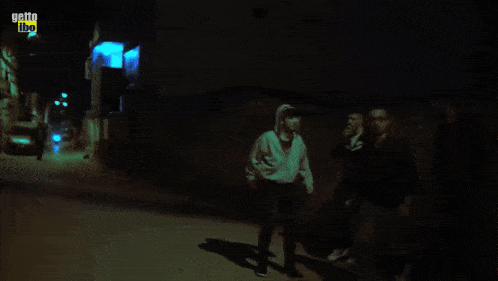 three men are walking down a dark alleyway with the words getto libo on the bottom right