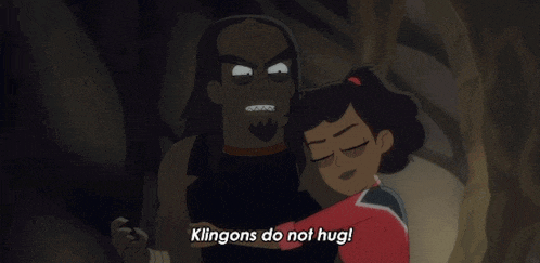 a cartoon of a girl hugging a man with the words " klingons do not hug " on the bottom