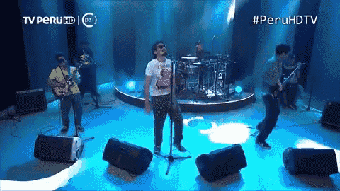 a group of people are playing instruments on a stage with a tv peru hd logo behind them
