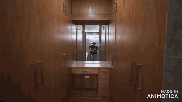 a man is taking a picture of himself in a mirror in a room made in animatica