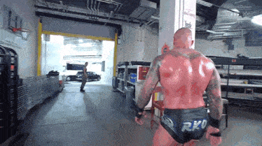 a man in a wrestling outfit with the word rko on his trunks