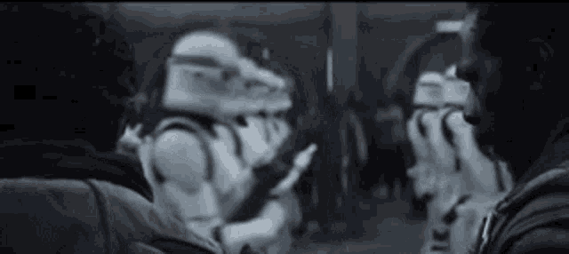 a black and white photo of a group of stormtroopers standing next to each other in a room .