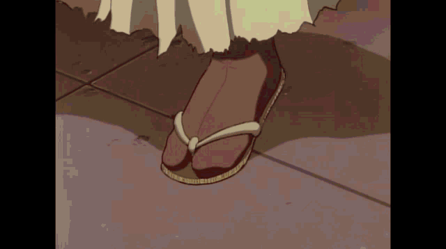 a close up of a person 's foot wearing a pair of flip flops