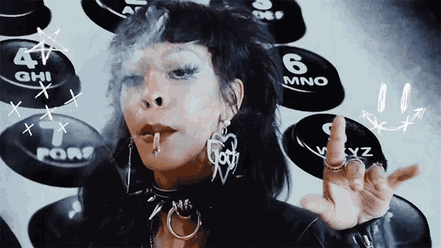 a woman smoking a cigarette in front of a wall of phone buttons with the number 6 on it